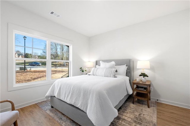 bedroom with hardwood / wood-style flooring