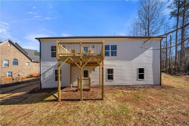 rear view of property featuring a deck