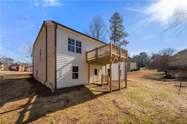 back of property featuring a yard and a deck