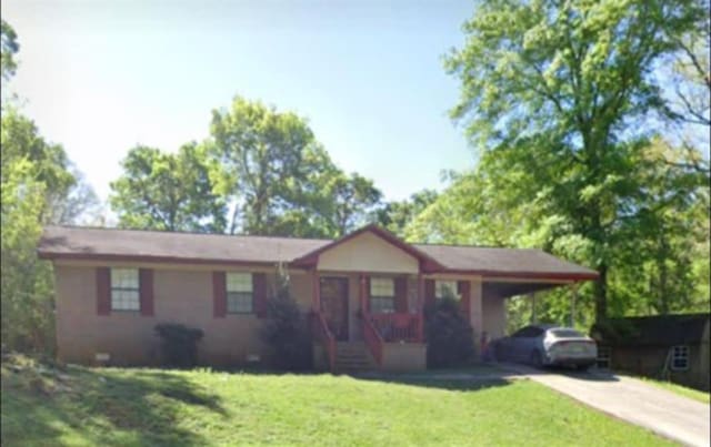 ranch-style house featuring driveway, an attached carport, crawl space, a front lawn, and a porch