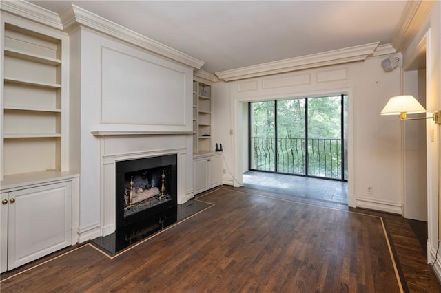 2769 Peachtree Rd NE Unit 7, Atlanta, GA 30305 - unfurnished living room featuring built in shelves, ornamental molding, dark wood finished floors, and a fireplace with raised hearth