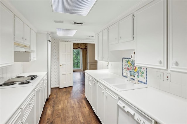 2769 Peachtree Rd NE Unit 7, Atlanta, GA 30305 - kitchen featuring white appliances, under cabinet range hood, white cabinets, light countertops, and backsplash