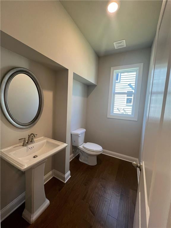 bathroom featuring hardwood / wood-style floors and toilet