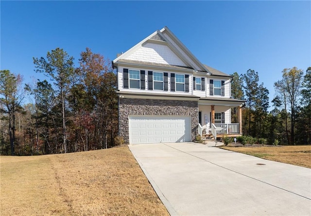 view of front facade featuring a garage, a front yard, and a porch