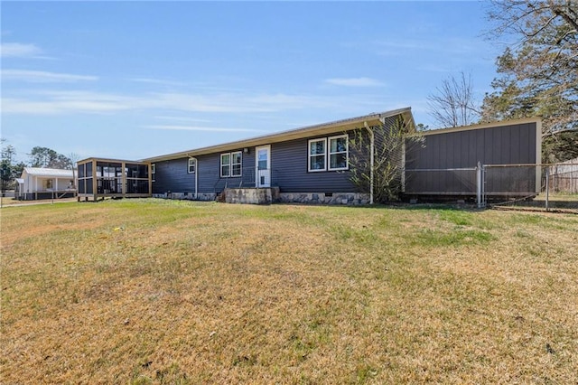 view of front of house with a front yard, fence, a sunroom, and crawl space