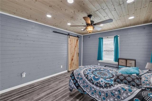 bedroom with wood finished floors, recessed lighting, a barn door, wooden ceiling, and baseboards