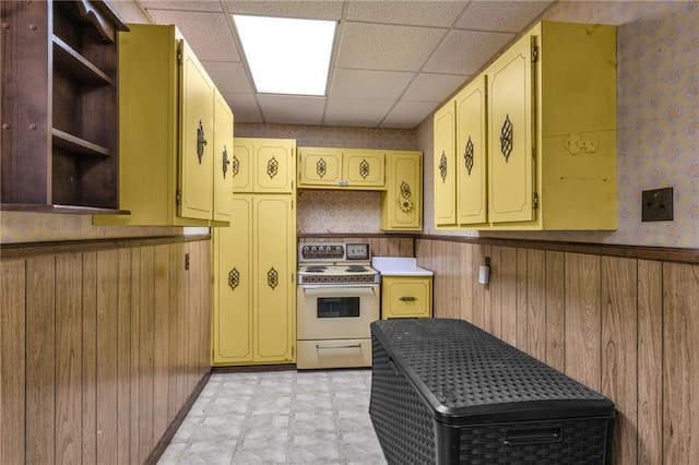 kitchen with wallpapered walls, a wainscoted wall, white electric range oven, a paneled ceiling, and open shelves