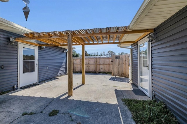 view of patio / terrace with a carport and fence