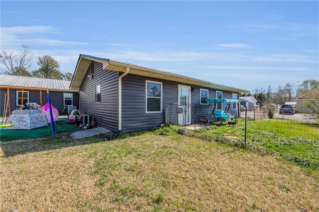 exterior space with a lawn and fence