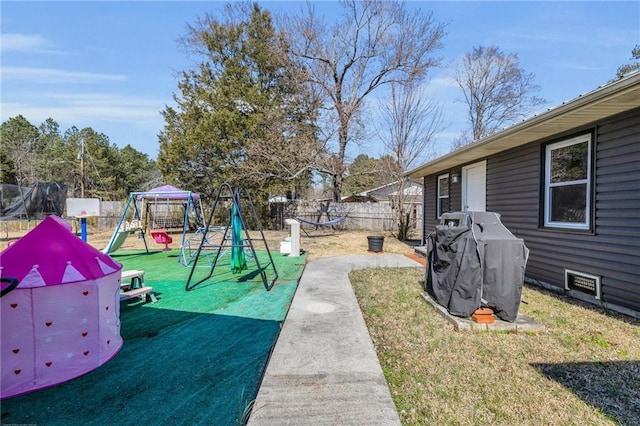 view of yard with fence and a playground