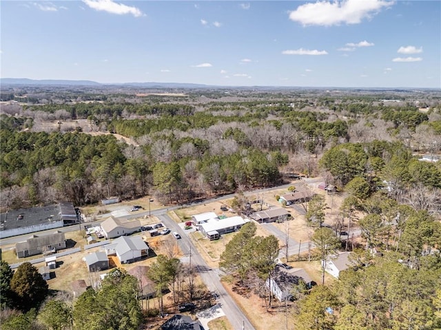 drone / aerial view featuring a wooded view