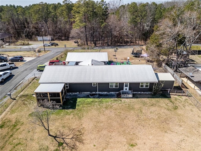 birds eye view of property featuring a wooded view