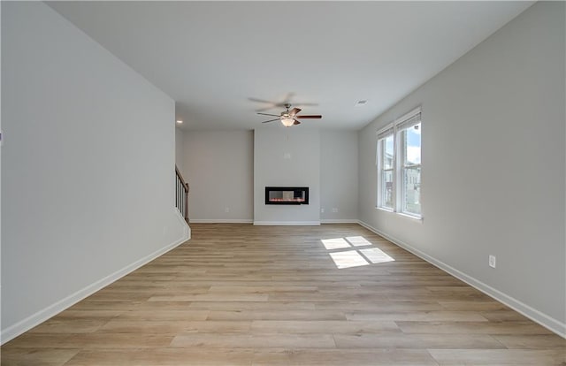 unfurnished living room with light hardwood / wood-style floors and ceiling fan