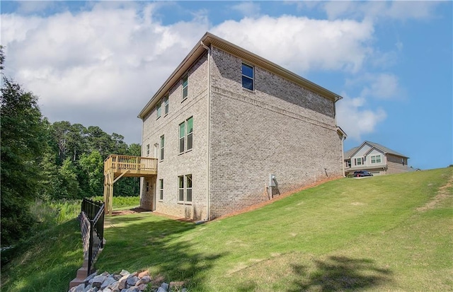 view of property exterior featuring a lawn and a wooden deck