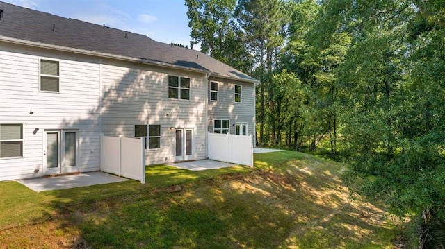 1317 Aura Ln, Lawrenceville, GA 30045 - back of property with a lawn and a patio area