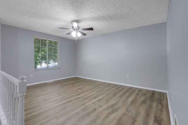 5295 Old Trail Cir, Stone Mountain, GA 30088 - unfurnished room featuring a ceiling fan, wood finished floors, a textured ceiling, and baseboards