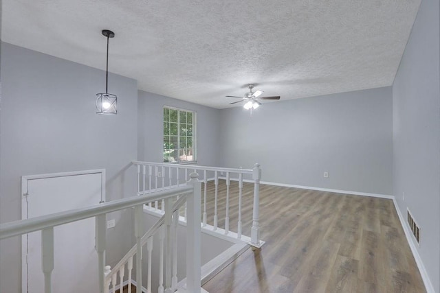 5295 Old Trail Cir, Stone Mountain, GA 30088 - staircase featuring wood finished floors, a textured ceiling, ceiling fan, and baseboards