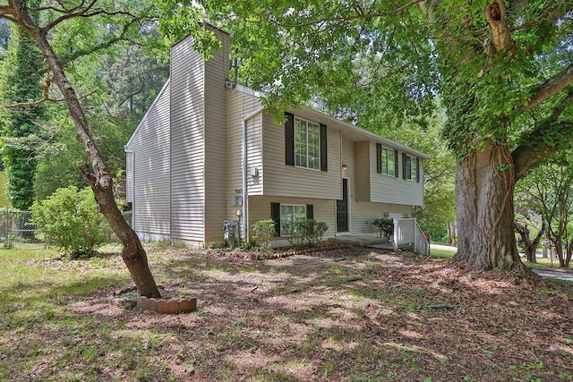 5295 Old Trail Cir, Stone Mountain, GA 30088 - split foyer home with a chimney and fence