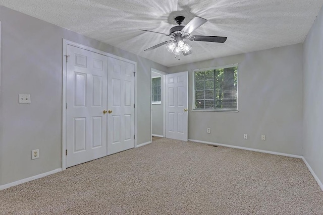 5295 Old Trail Cir, Stone Mountain, GA 30088 - unfurnished bedroom with a textured ceiling, carpet floors, baseboards, a closet, and a ceiling fan