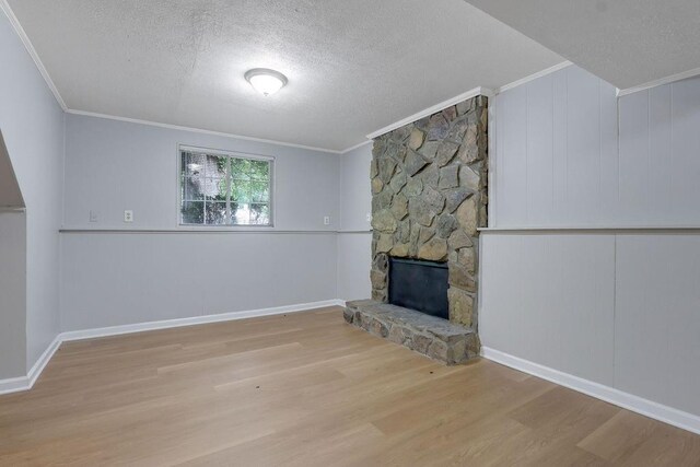 5295 Old Trail Cir, Stone Mountain, GA 30088 - unfurnished living room featuring a textured ceiling, ornamental molding, wood finished floors, a fireplace, and baseboards
