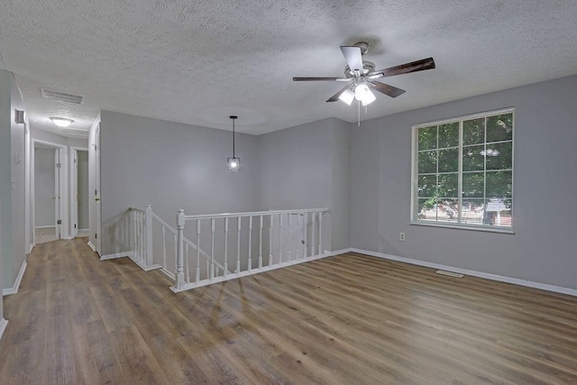 5295 Old Trail Cir, Stone Mountain, GA 30088 - spare room with wood finished floors, a textured ceiling, baseboards, and a ceiling fan