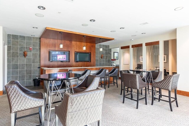 dining space featuring tile walls