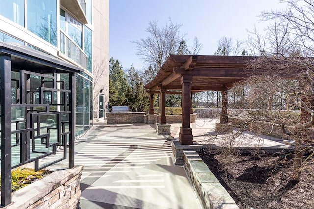 view of patio / terrace featuring a pergola and an outdoor kitchen