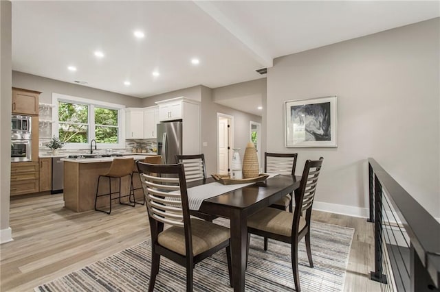 1510 Mims St SW, Atlanta, GA 30314 - dining area with visible vents, beam ceiling, recessed lighting, light wood finished floors, and baseboards