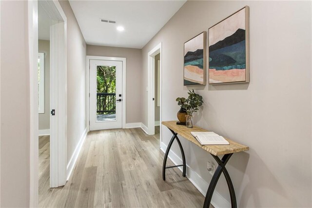 doorway with light wood-type flooring