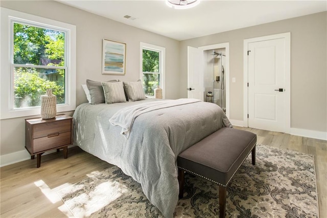 bedroom featuring light hardwood / wood-style flooring and multiple windows