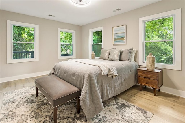 1510 Mims St SW, Atlanta, GA 30314 - bedroom featuring multiple windows, wood finished floors, visible vents, and baseboards