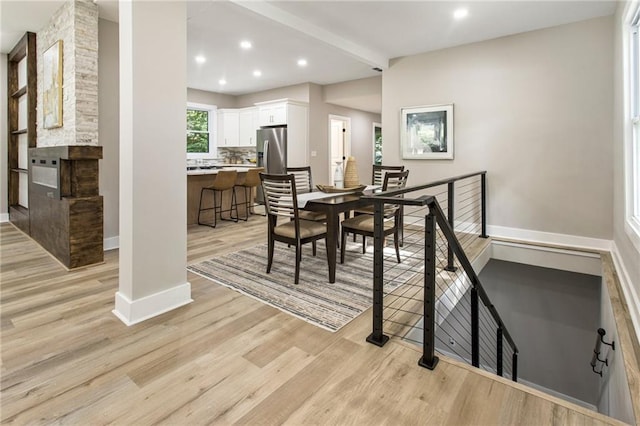 1510 Mims St SW, Atlanta, GA 30314 - dining room featuring baseboards, light wood finished floors, beam ceiling, a fireplace, and recessed lighting