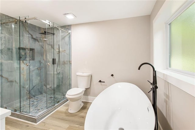 bathroom featuring toilet, hardwood / wood-style floors, and walk in shower