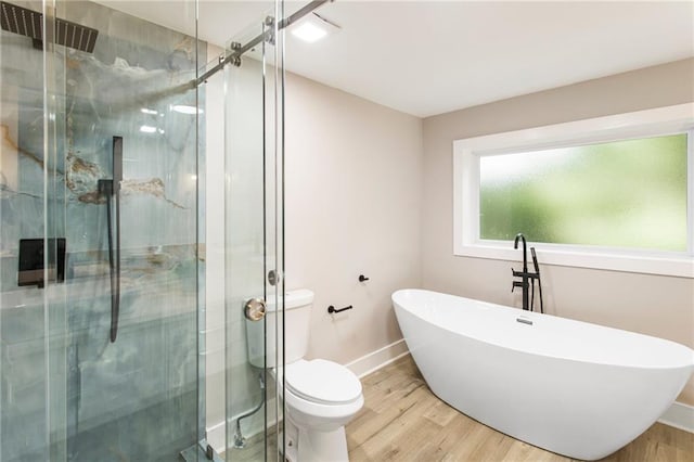 1510 Mims St SW, Atlanta, GA 30314 - full bathroom with a soaking tub, a stall shower, toilet, and wood finished floors