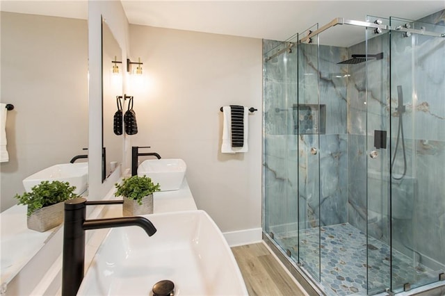 bathroom featuring double sink vanity, hardwood / wood-style floors, and an enclosed shower