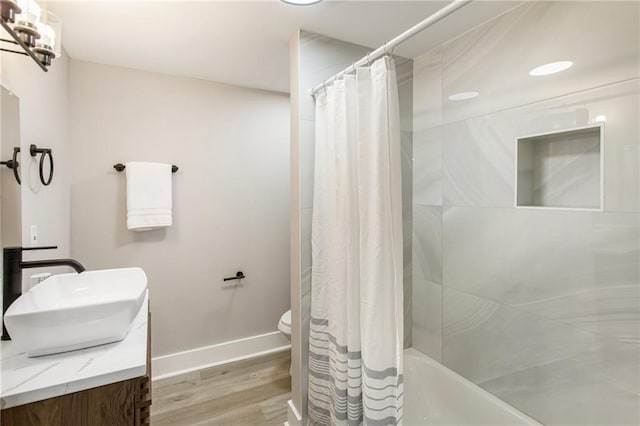 full bathroom with vanity, shower / bath combo, hardwood / wood-style flooring, and toilet