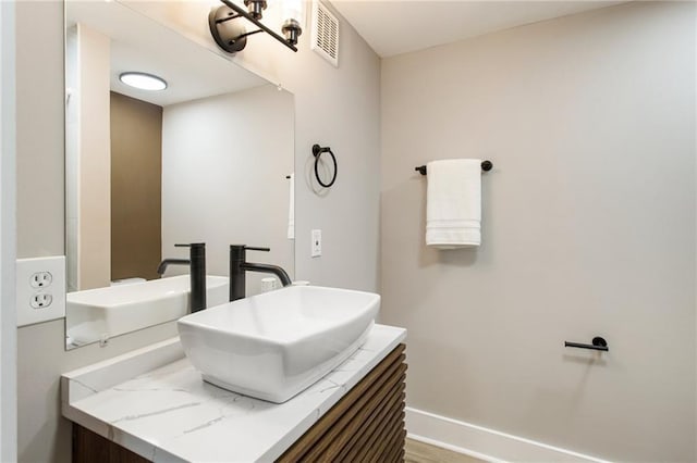 1510 Mims St SW, Atlanta, GA 30314 - bathroom with visible vents, baseboards, and vanity