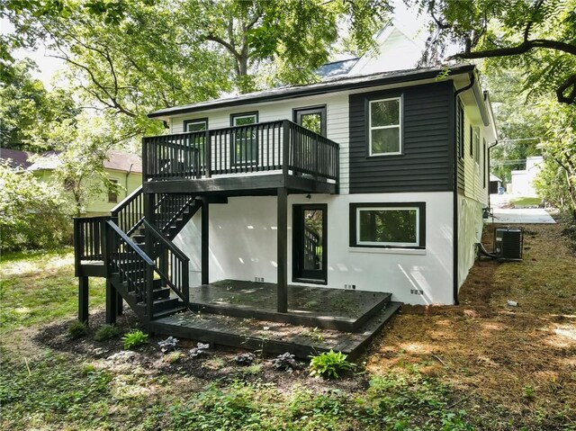 back of property with a deck and cooling unit