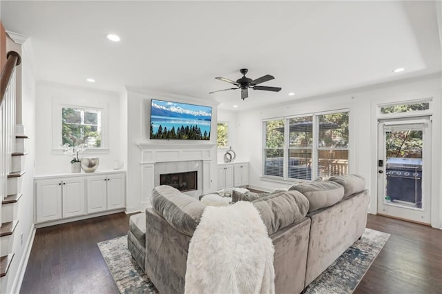 kitchen with an island with sink, white cabinets, dark hardwood / wood-style floors, and high end stainless steel range oven