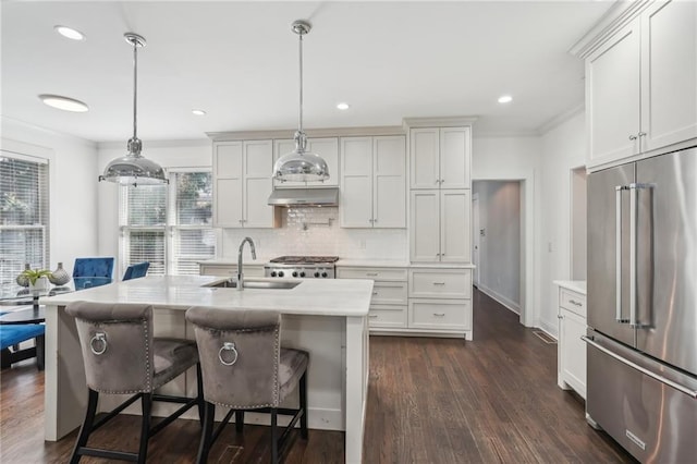 dining area featuring a wealth of natural light, dark wood-type flooring, crown molding, and an inviting chandelier