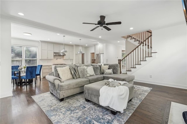 kitchen with hanging light fixtures, dark hardwood / wood-style flooring, an island with sink, sink, and premium appliances