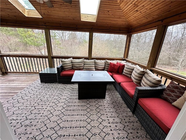 sunroom / solarium featuring a skylight and ceiling fan