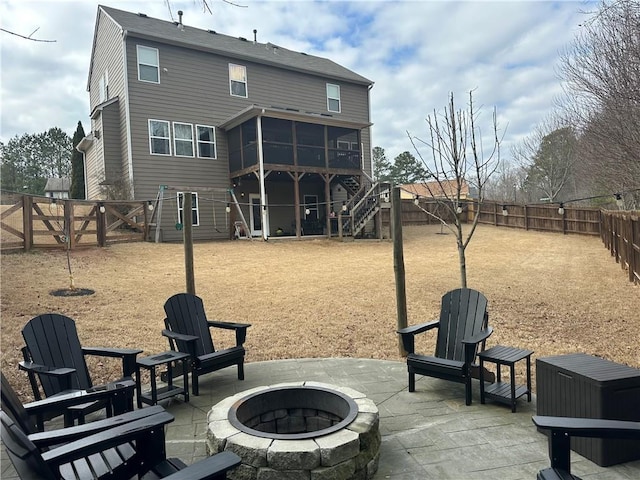 exterior space with a fire pit, a sunroom, and a patio