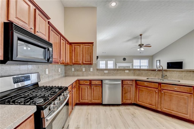 609 Grand Ashbury Ln, Buford, GA 30518 - kitchen with light countertops, a ceiling fan, appliances with stainless steel finishes, and a sink