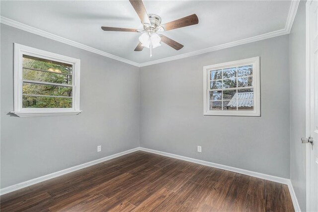 empty room featuring ceiling fan, ornamental molding, dark wood-type flooring, and electric panel