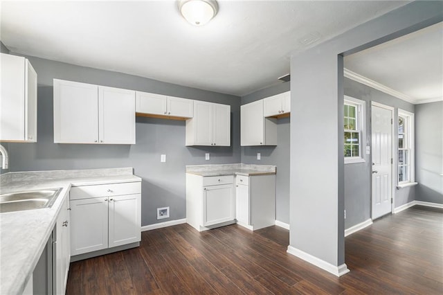 kitchen featuring dark hardwood / wood-style floors, white cabinetry, and sink