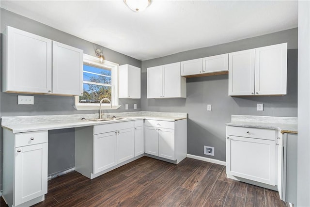 kitchen featuring sink, white cabinets, and dark wood-type flooring