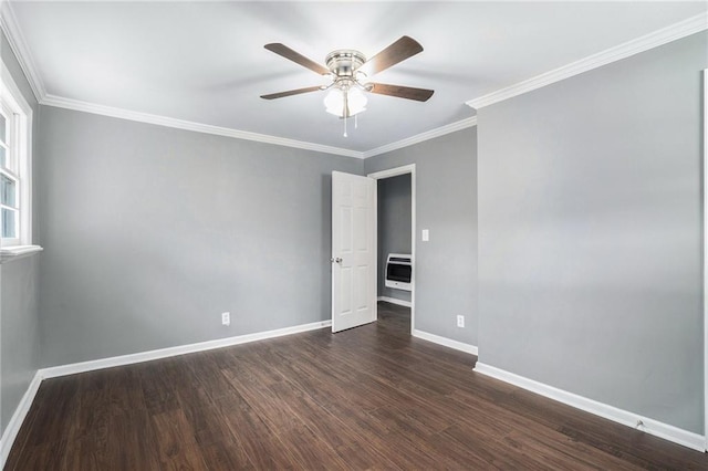 empty room featuring heating unit, ceiling fan, dark hardwood / wood-style floors, and ornamental molding