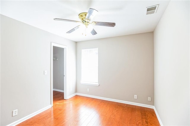 empty room with ceiling fan and light wood-type flooring