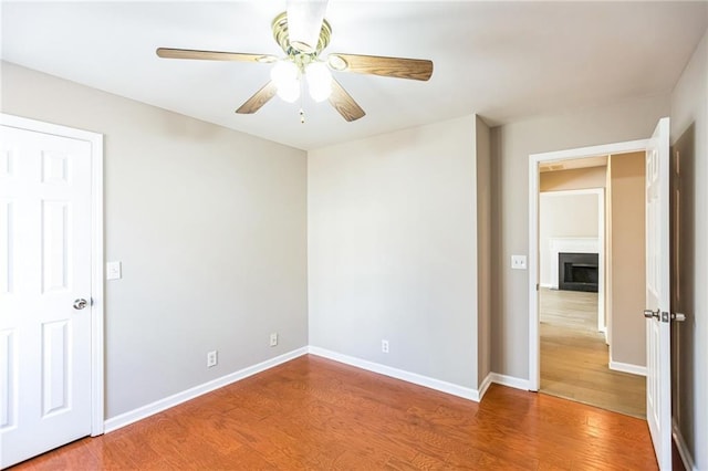 spare room with hardwood / wood-style flooring and ceiling fan